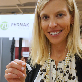 Dr. Christine Jones, Director of Phonak Audiology Research Center, with Audeo B-Direct